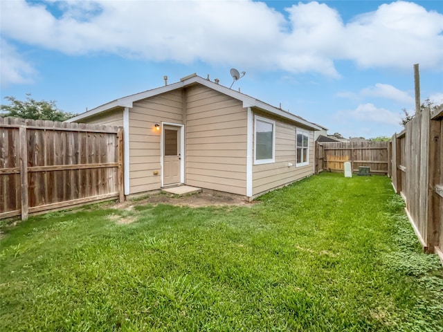 rear view of property featuring a yard