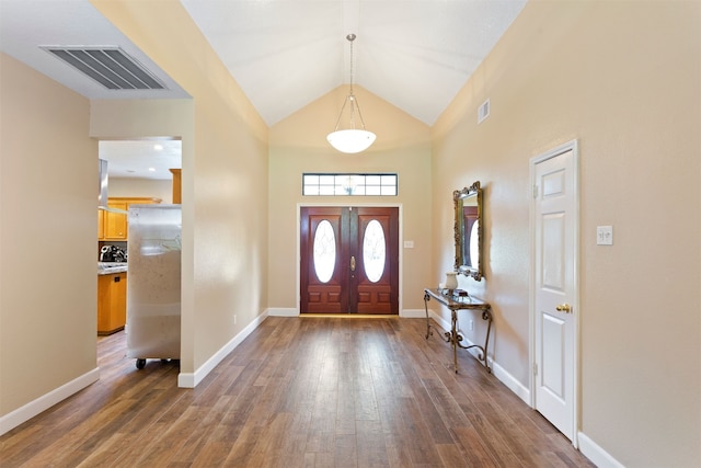 foyer with dark hardwood / wood-style floors and high vaulted ceiling