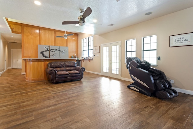 interior space featuring wood-type flooring, a textured ceiling, french doors, and ceiling fan