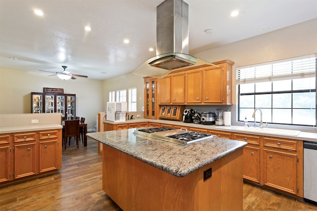 kitchen featuring a center island, ceiling fan, island range hood, and dark hardwood / wood-style floors