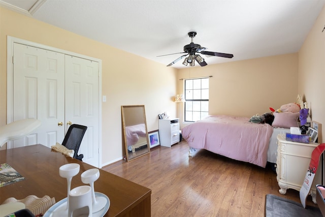 bedroom with a closet, ceiling fan, and hardwood / wood-style flooring