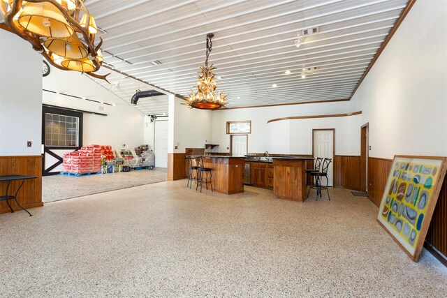 kitchen featuring a chandelier, a kitchen breakfast bar, and pendant lighting