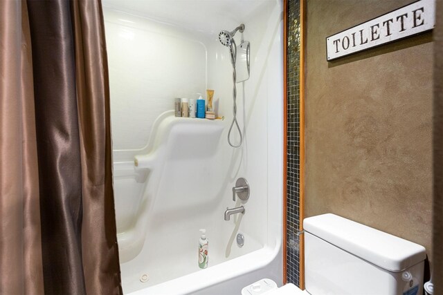 bathroom with shower / bath combination with curtain and toilet