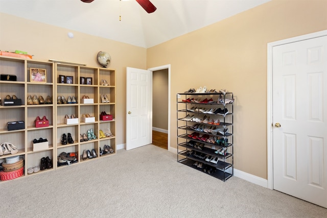 interior space with vaulted ceiling, ceiling fan, and carpet floors