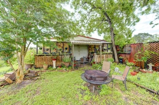 view of yard with an outdoor fire pit and an outdoor structure