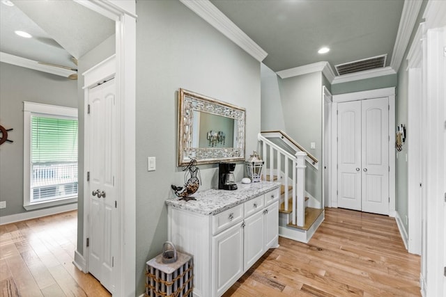 hall featuring light hardwood / wood-style floors and crown molding