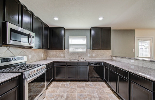 kitchen with a healthy amount of sunlight, light tile floors, and stainless steel appliances