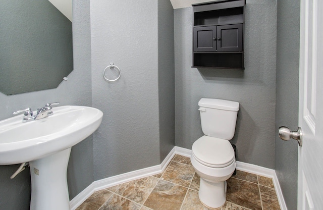 bathroom featuring tile floors and toilet