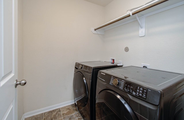 clothes washing area with tile flooring, hookup for an electric dryer, hookup for a washing machine, and washer and clothes dryer