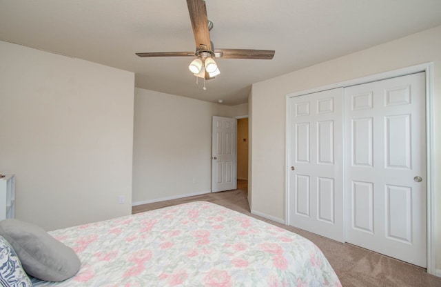 bedroom with a closet, ceiling fan, and light colored carpet