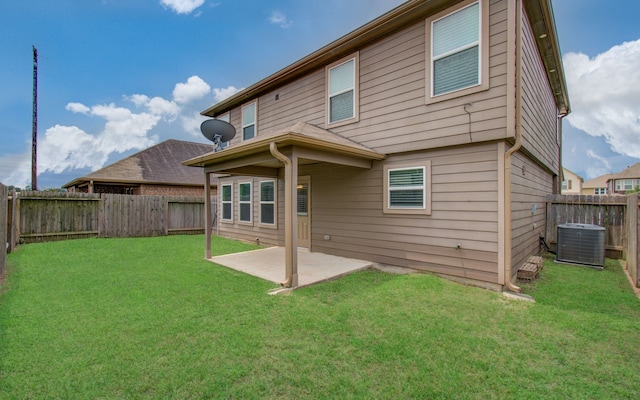 rear view of house featuring a patio, central AC unit, and a yard