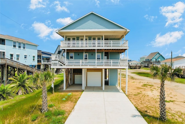 raised beach house with a balcony and a garage