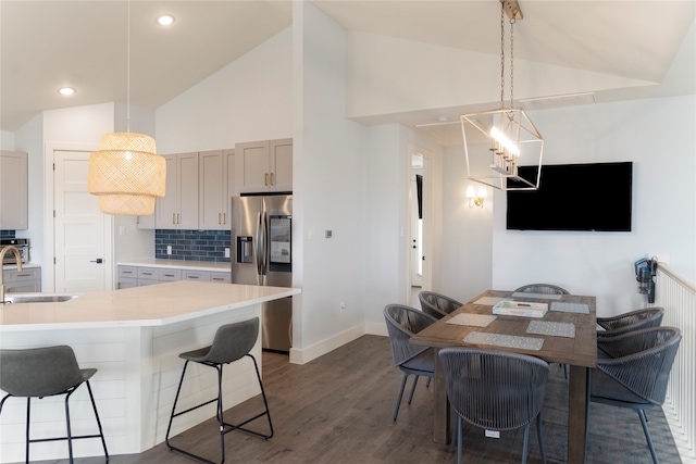 kitchen with dark hardwood / wood-style floors, stainless steel fridge, sink, pendant lighting, and gray cabinets