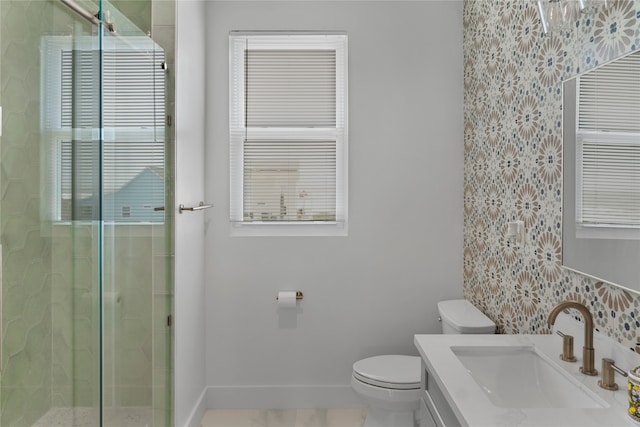 bathroom with tile patterned floors, vanity, toilet, and a shower with shower door