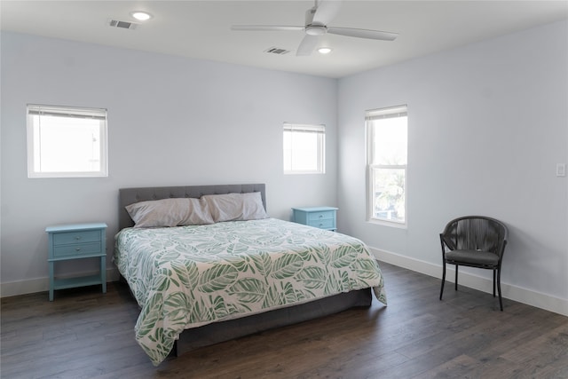 bedroom with dark hardwood / wood-style floors and ceiling fan