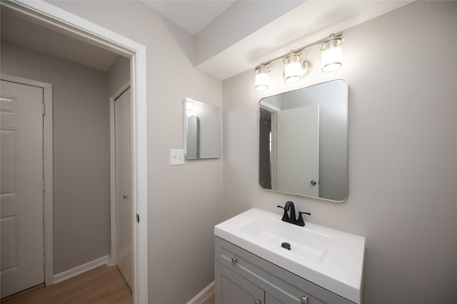 bathroom with vanity and hardwood / wood-style flooring