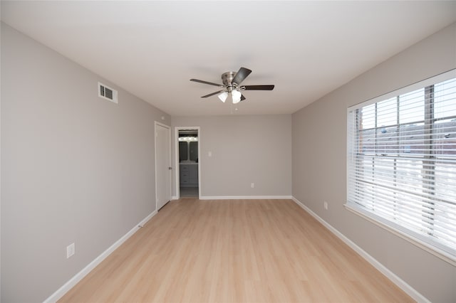 empty room featuring ceiling fan and light wood-type flooring