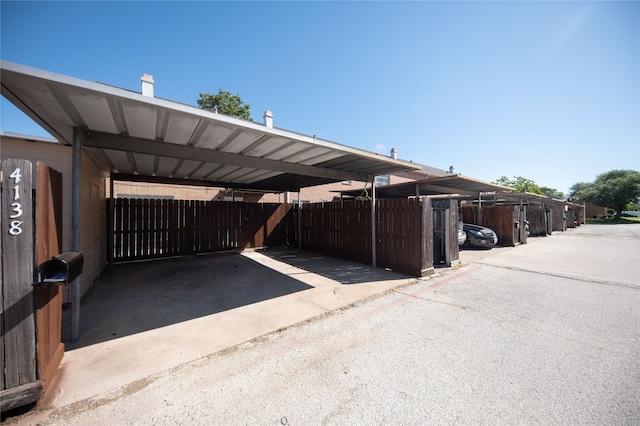 view of vehicle parking with a carport