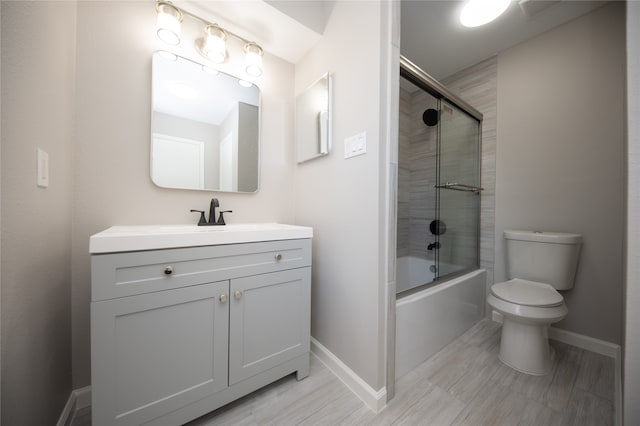 full bathroom featuring vanity, toilet, and enclosed tub / shower combo