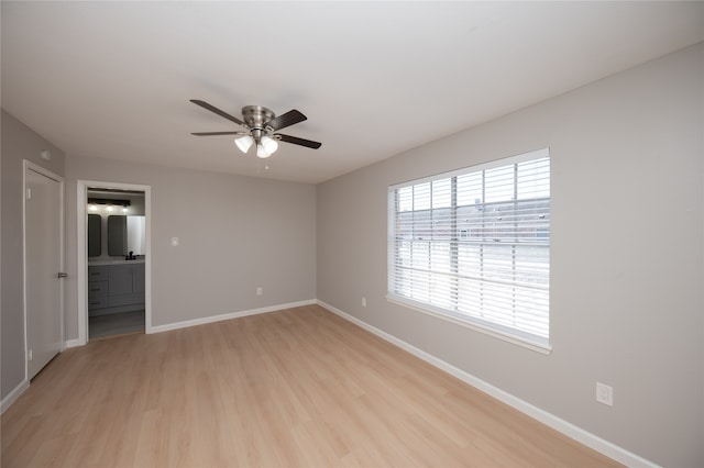 spare room with ceiling fan and light wood-type flooring