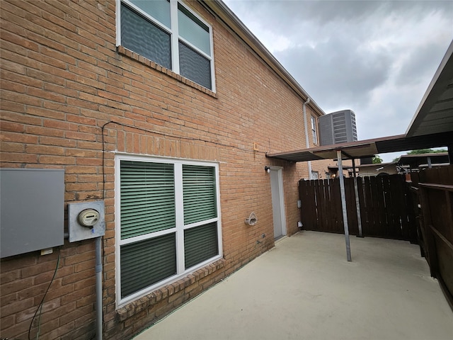 view of property exterior with a patio area and cooling unit