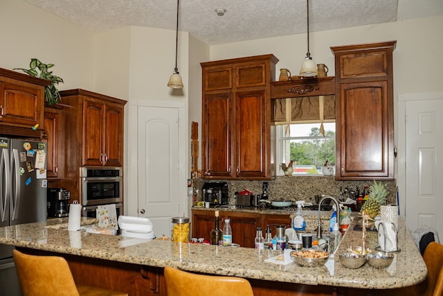 kitchen with appliances with stainless steel finishes, tasteful backsplash, a kitchen breakfast bar, and light stone countertops