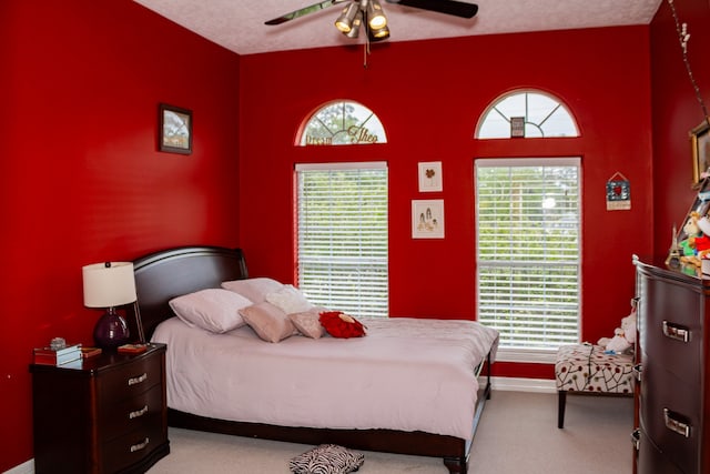 carpeted bedroom featuring ceiling fan and multiple windows