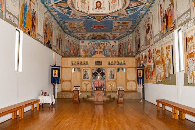 interior space featuring a high ceiling and hardwood / wood-style floors