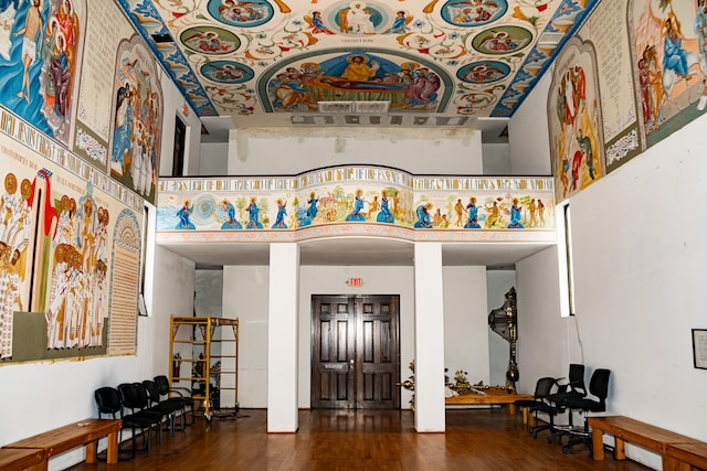 entryway with wood-type flooring and a high ceiling