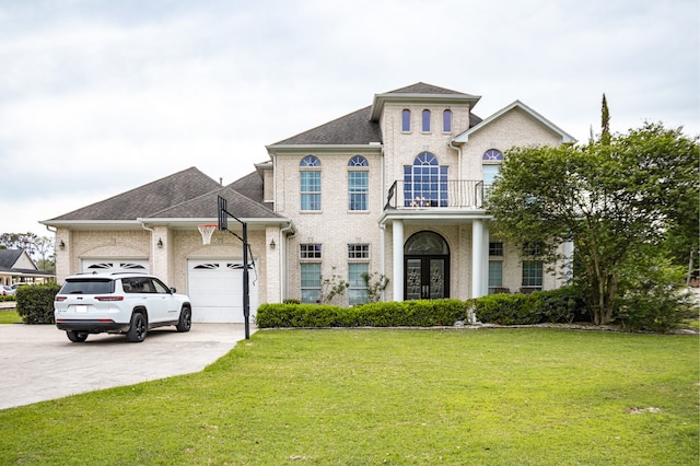 view of front of property with a garage, a balcony, and a front yard