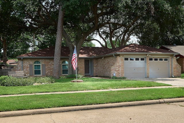 single story home featuring a garage and a front lawn