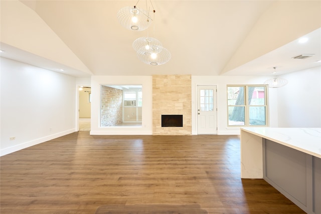 unfurnished living room with dark hardwood / wood-style flooring, a fireplace, and plenty of natural light