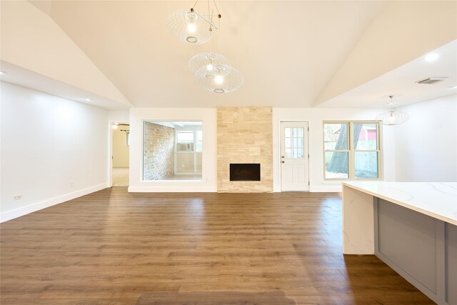 15830 Whipple Tree Dr, Houston, TX 77070 - unfurnished living room featuring wood finished floors, high vaulted ceiling, a fireplace, and baseboards