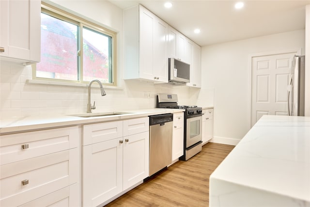 kitchen featuring white cabinetry, appliances with stainless steel finishes, and light hardwood / wood-style flooring