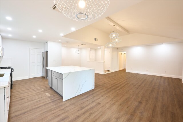 15830 Whipple Tree Dr, Houston, TX 77070 - kitchen featuring freestanding refrigerator, a chandelier, wood finished floors, light stone countertops, and recessed lighting