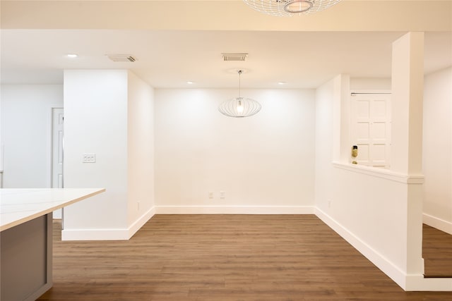 unfurnished dining area featuring dark hardwood / wood-style floors