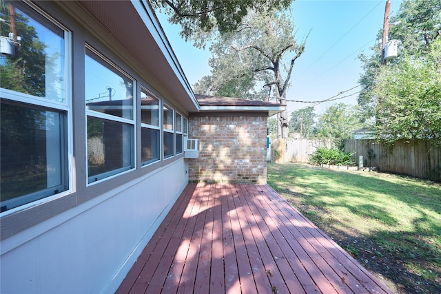 deck featuring a lawn and cooling unit