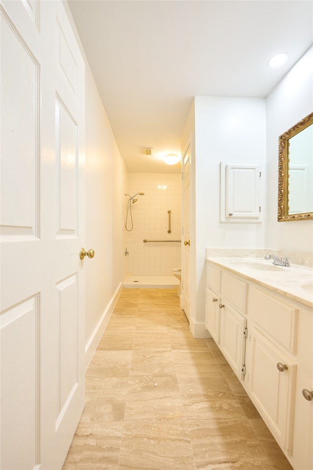 full bathroom featuring vanity, tiled shower / bath combo, and toilet