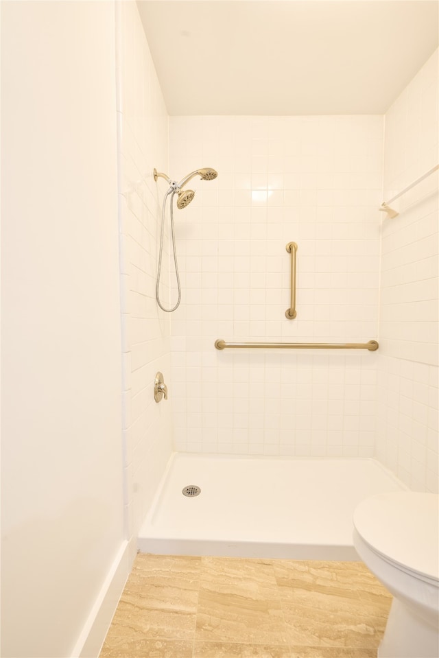 bathroom featuring toilet and tiled shower