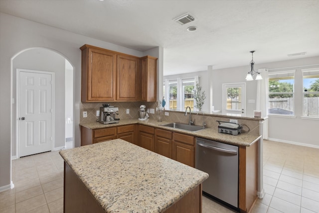 kitchen featuring a kitchen island, dishwasher, and light tile floors