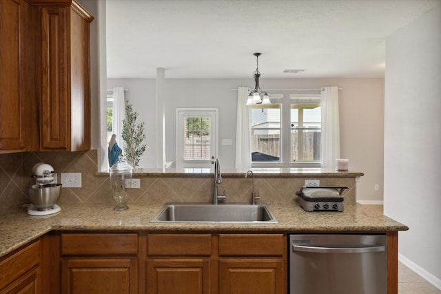 kitchen featuring sink, dishwasher, backsplash, light tile flooring, and pendant lighting