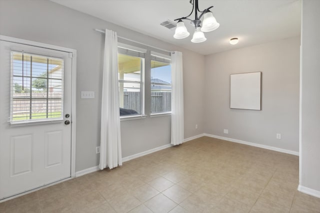 doorway featuring a notable chandelier and light tile floors