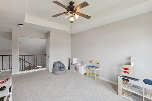 game room with a raised ceiling, ceiling fan, and carpet floors