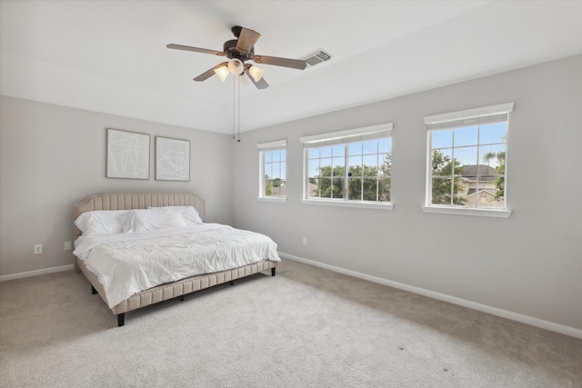 bedroom with ceiling fan, carpet, and multiple windows