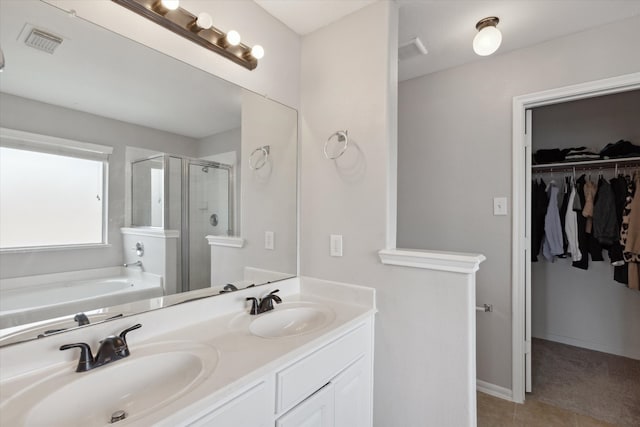 bathroom featuring double sink, tile floors, separate shower and tub, and large vanity