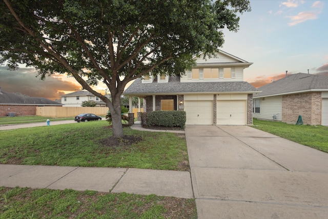 view of property with a yard and a garage