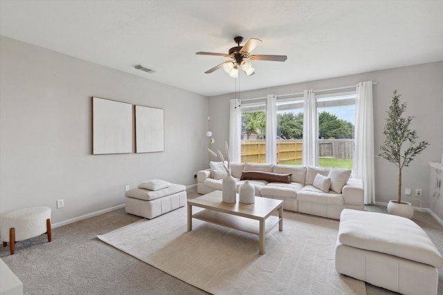 living room with ceiling fan and carpet flooring