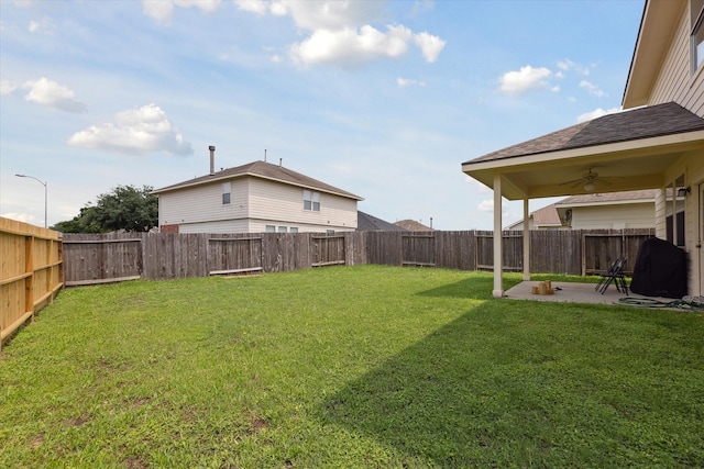 view of yard featuring ceiling fan and a patio