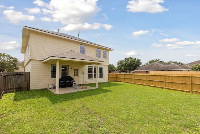 rear view of property with a patio area and a lawn