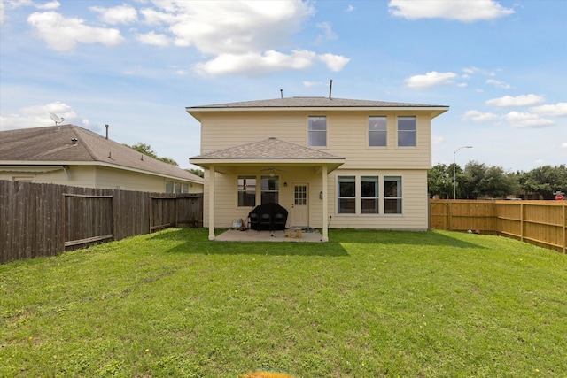 rear view of house with a yard and a patio